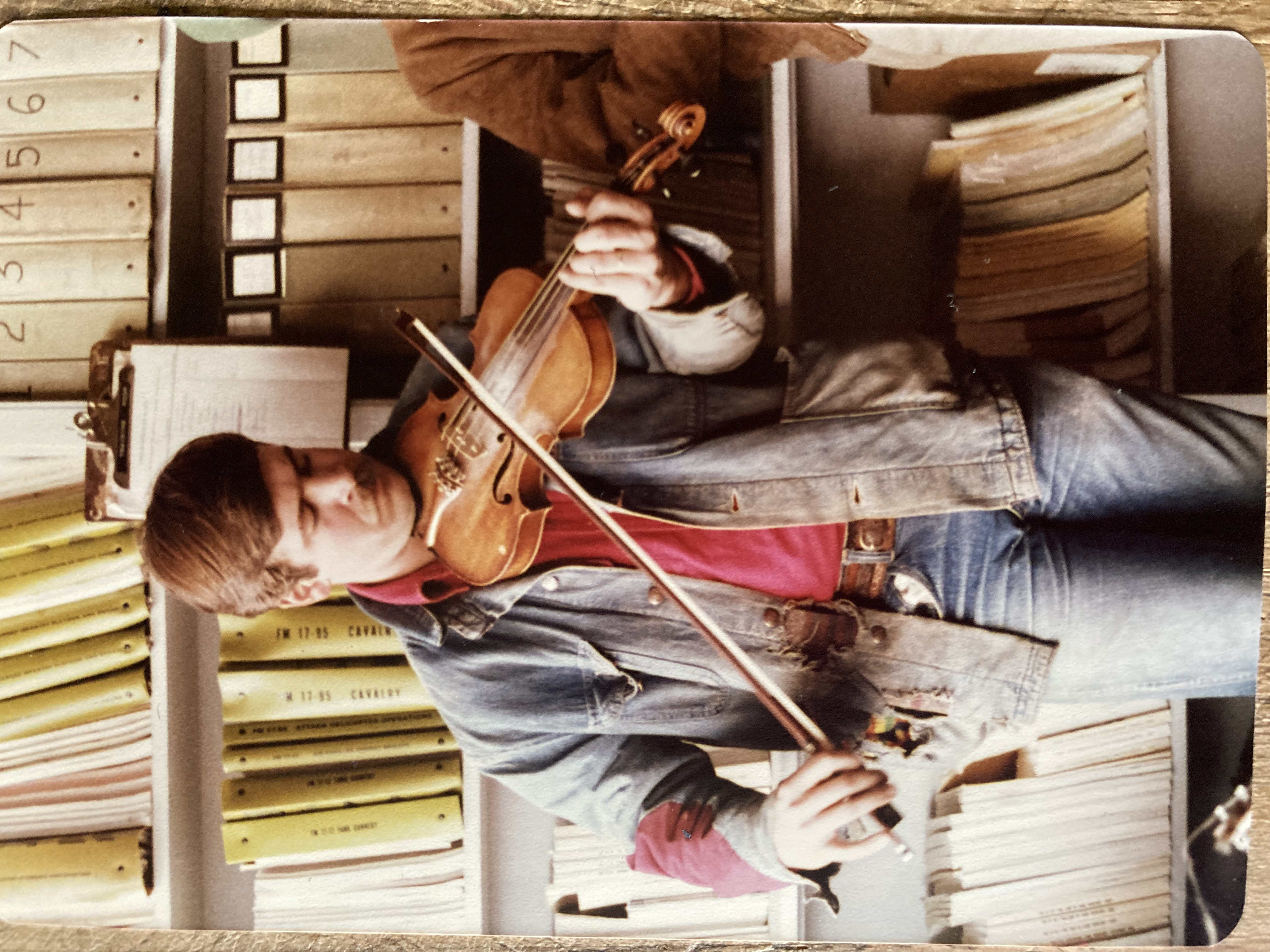 Gil Adams playing fiddle indoors